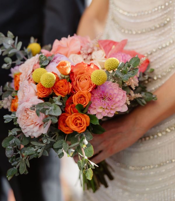 Bridal bouquet of peach roses and ranunculus